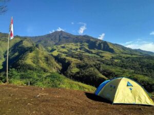 Spot camping Budug Asu di ketinggian dengan panorama alam luas dan langit cerah di atas awan.